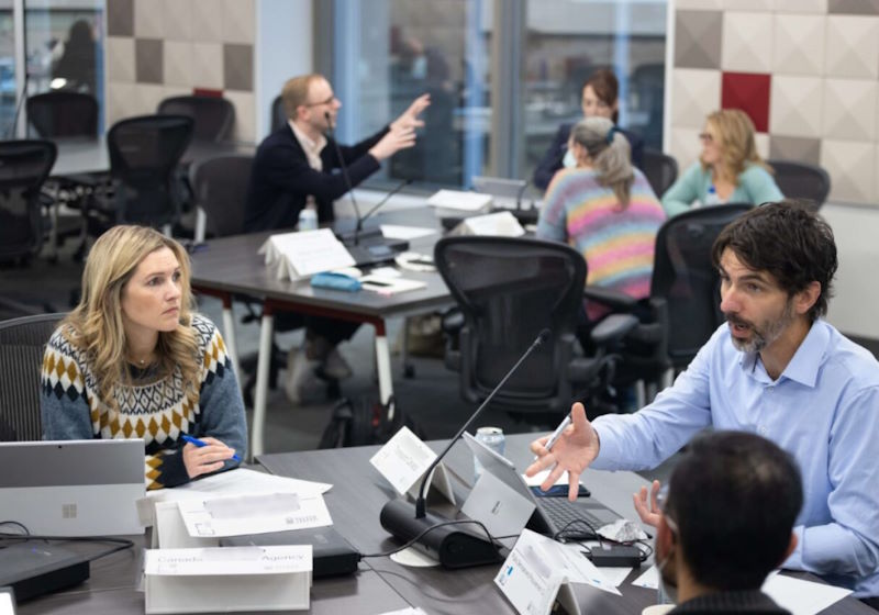 A group of executive participants work together in a classroom at the Telfer Centre for Executive Leadership.