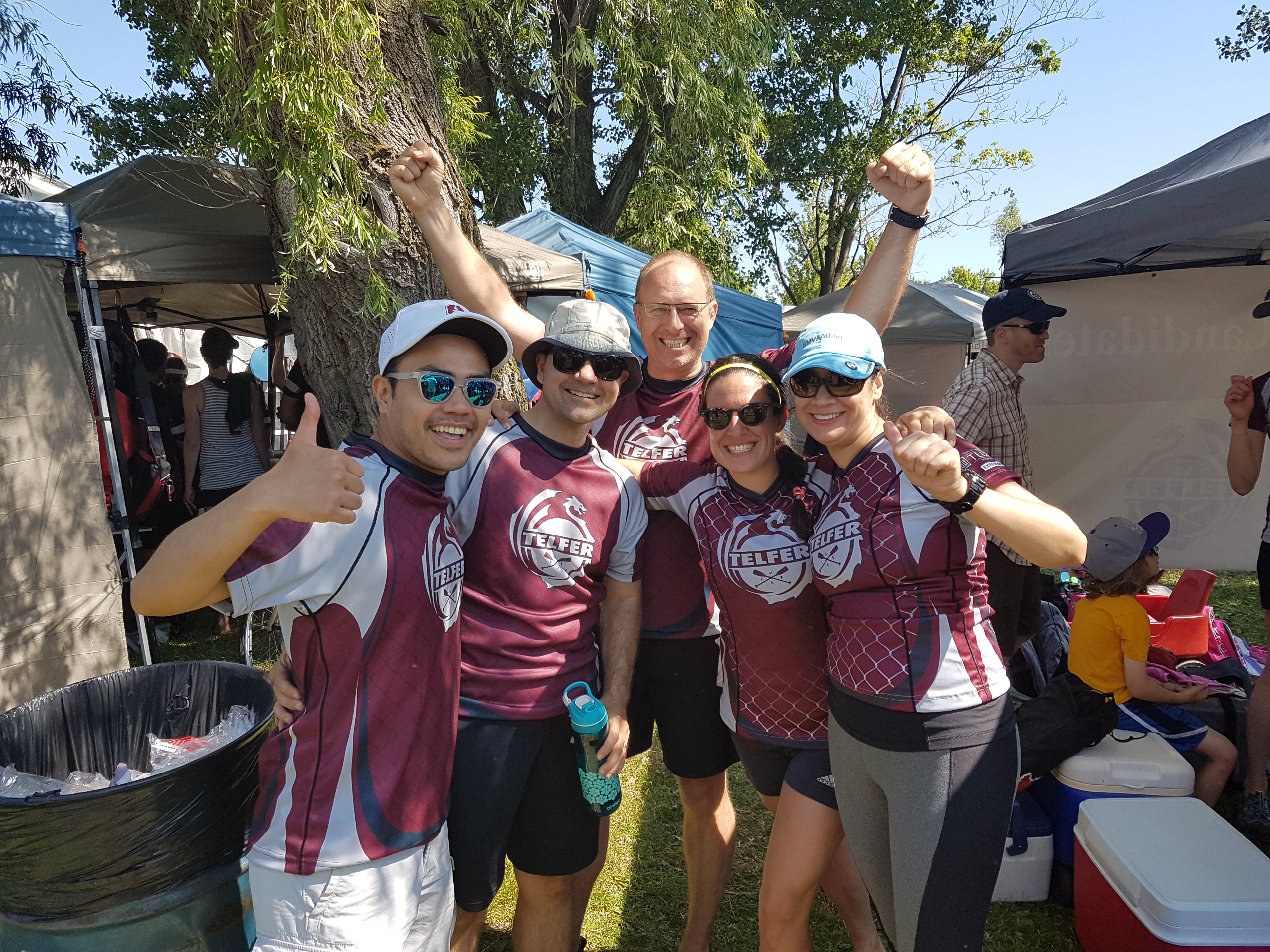Original photo of a team of Telfer alumni dragon boat team cheering after a race.