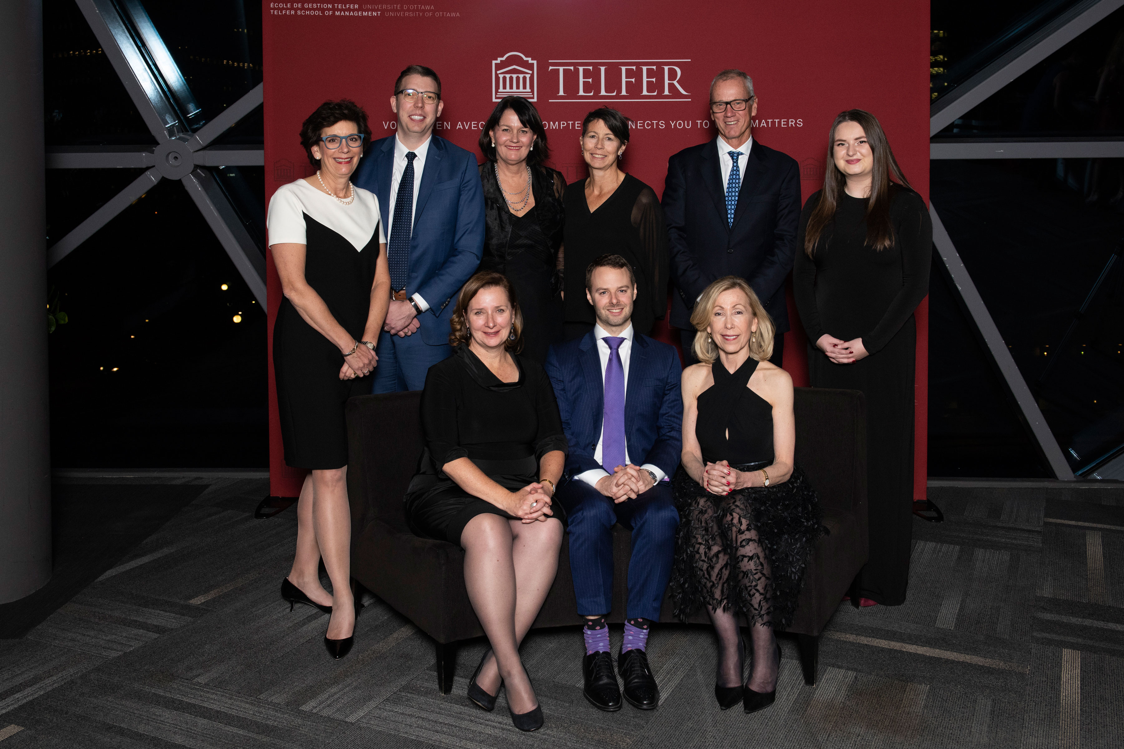 A group of Gala of excellence guests in front of a Telfer background