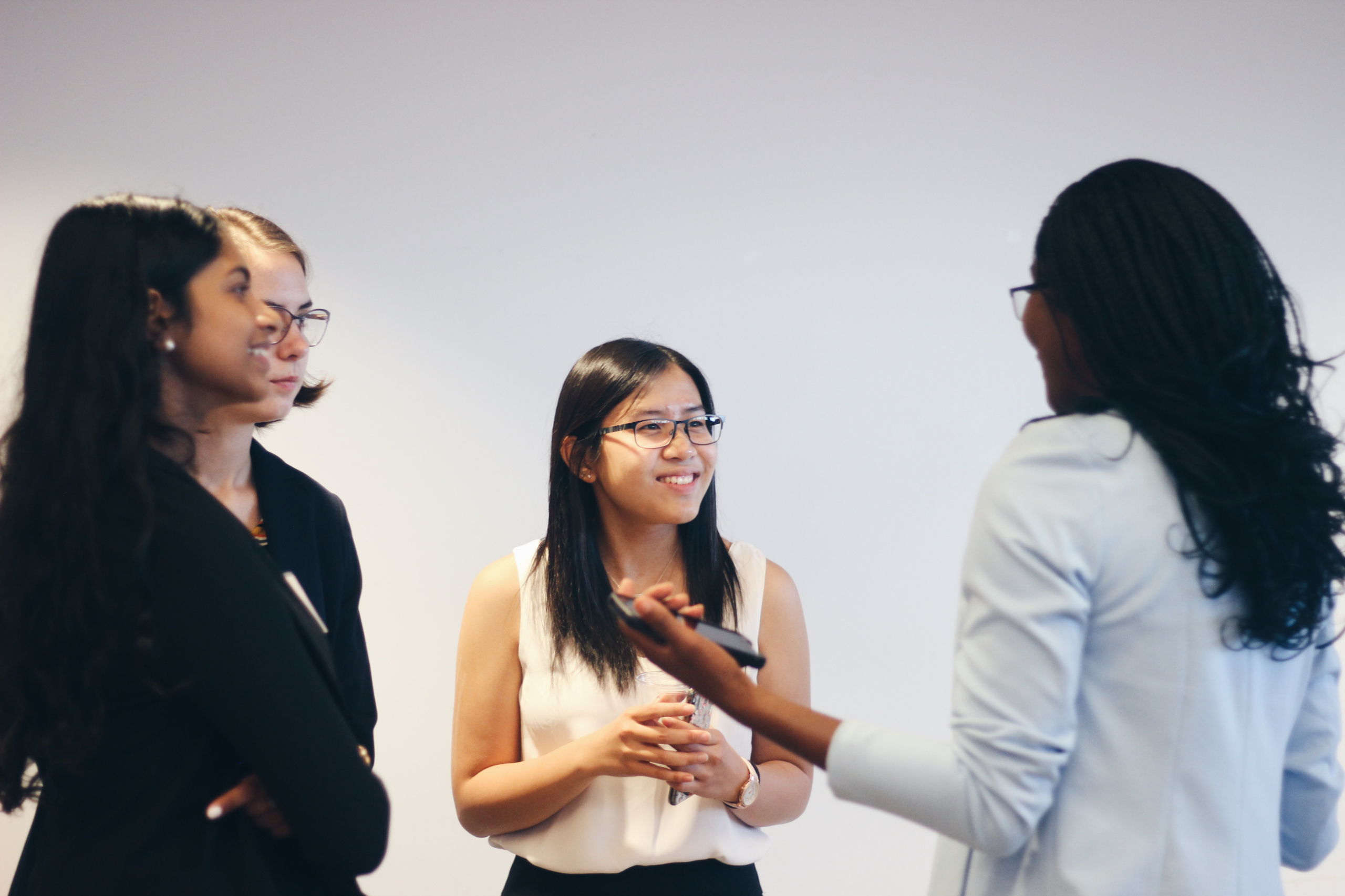 Group of young women discussing in a circle