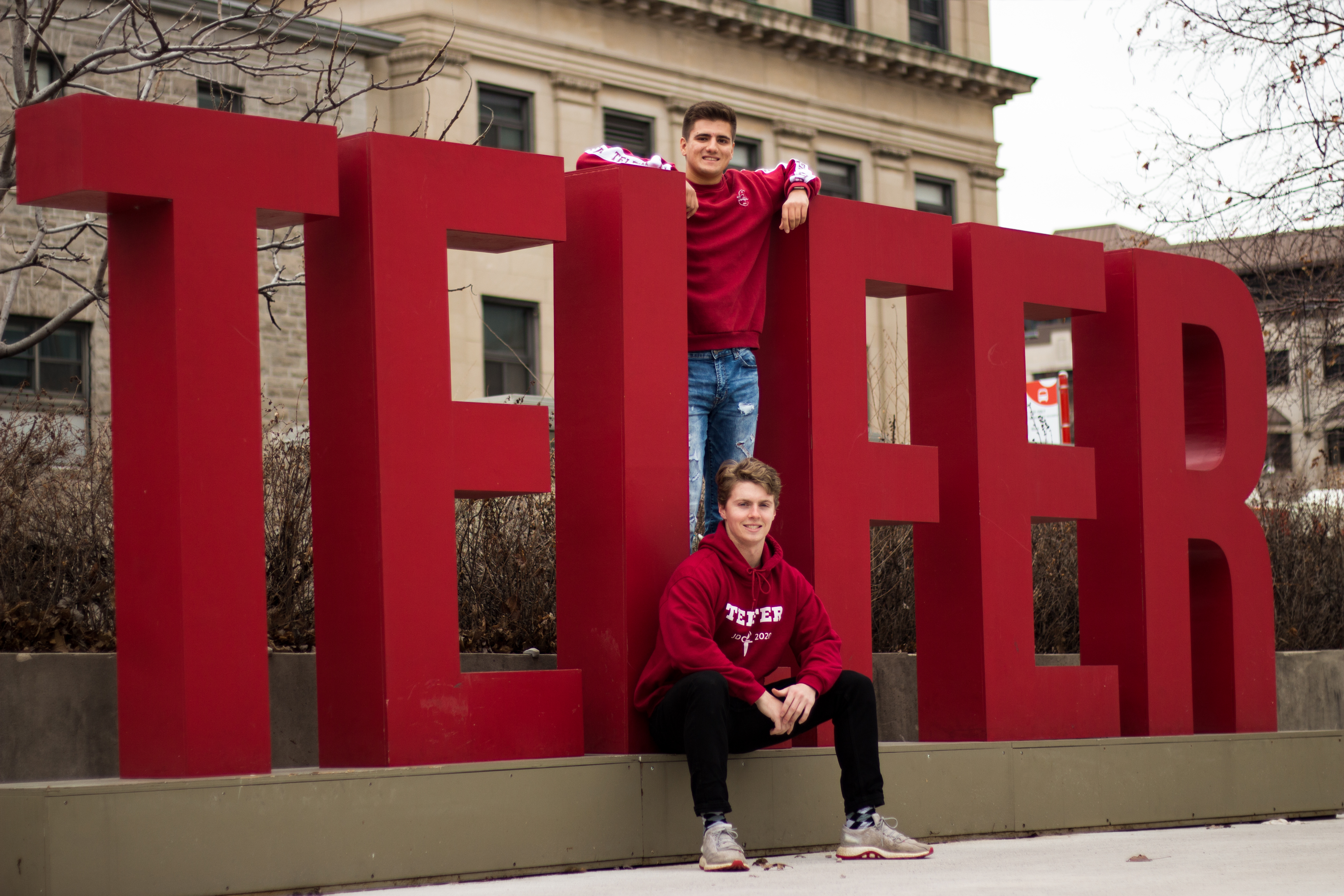 Telfer students in front of the Telfer sign on campus