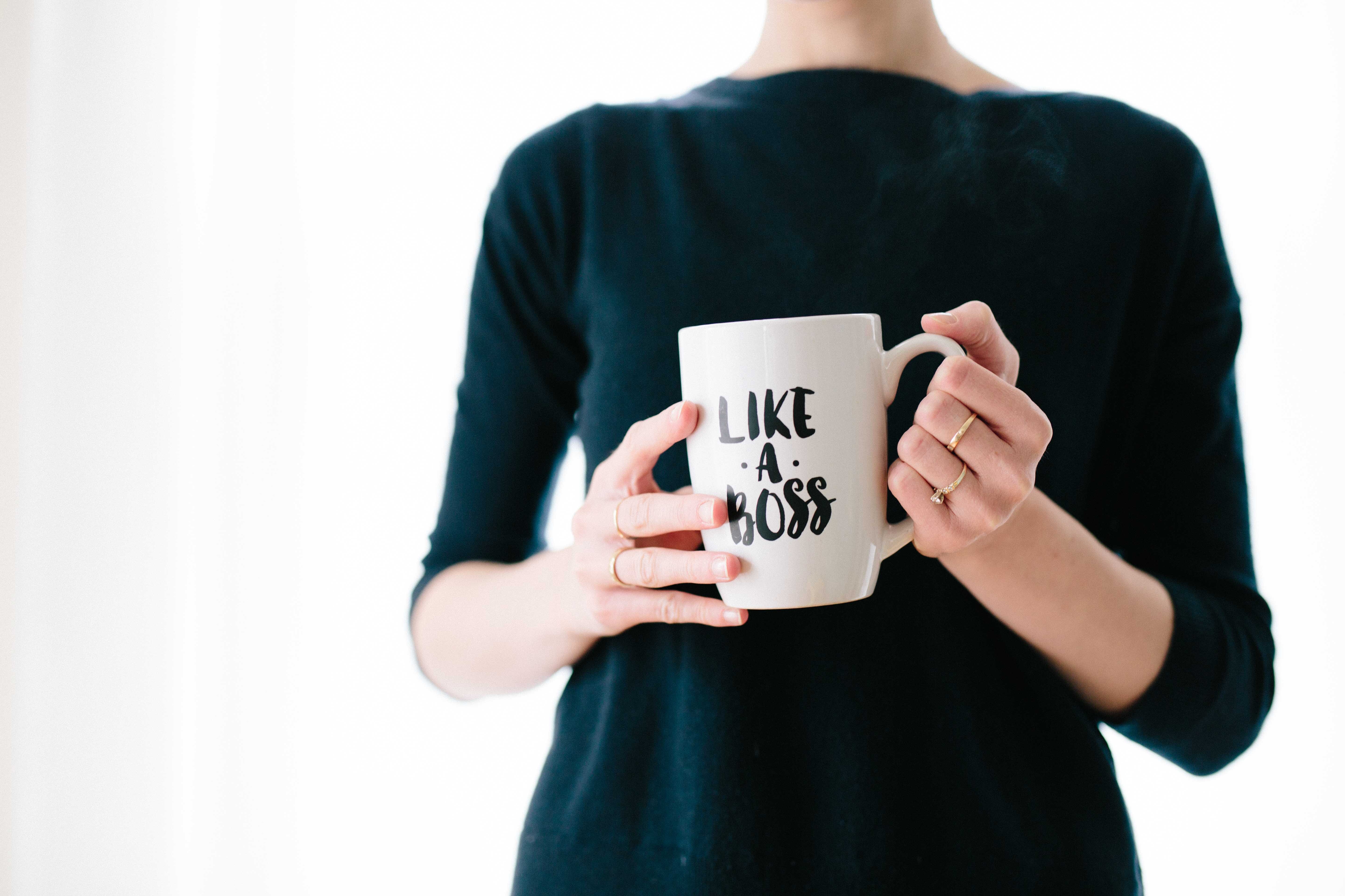 A person holding a `like a boss`mug