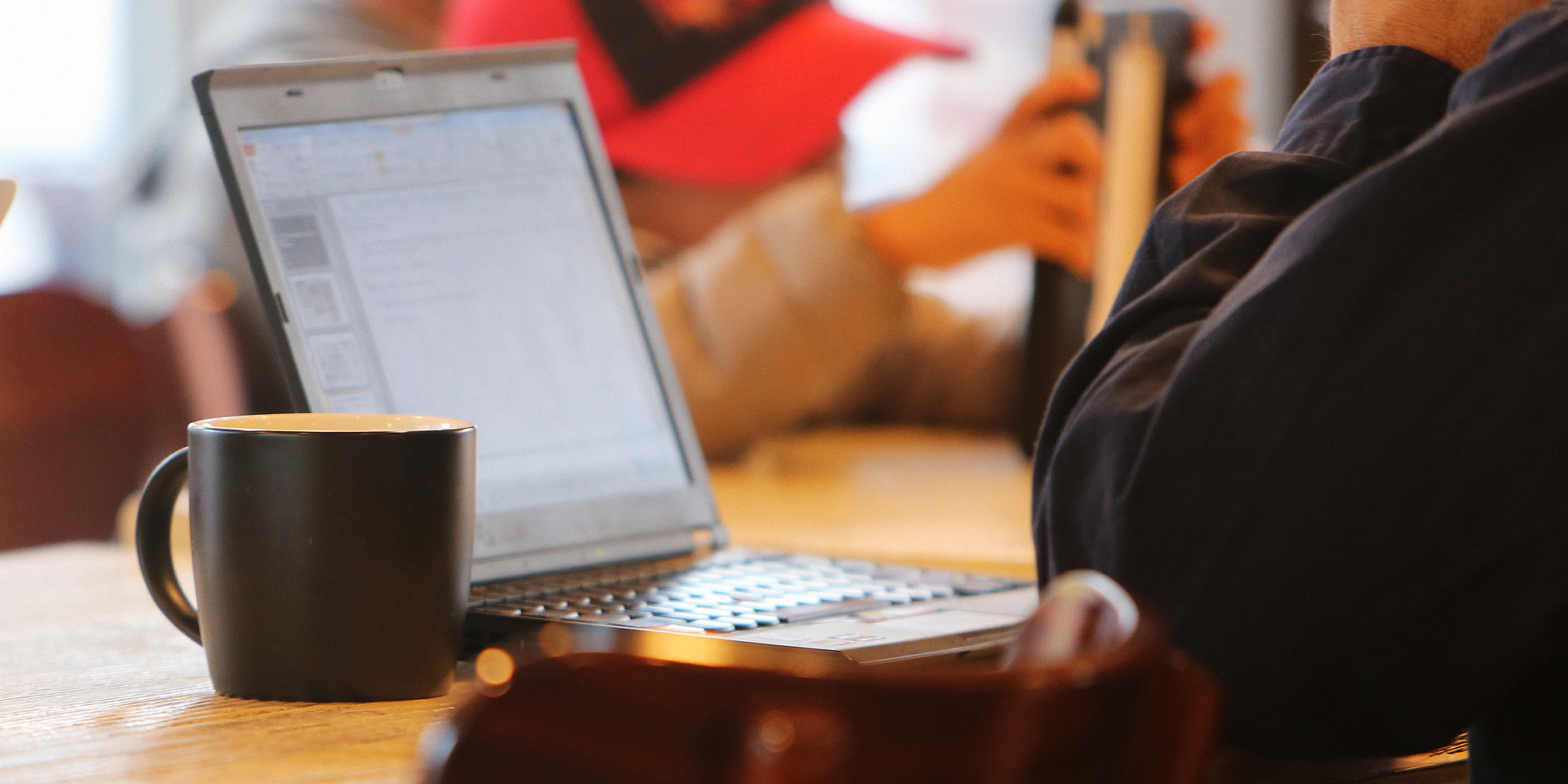 Student at coffee shop working on his laptop