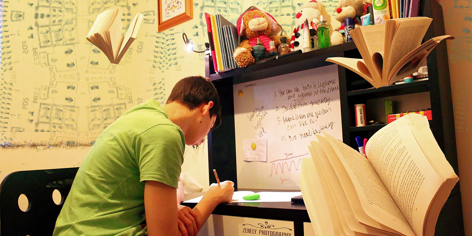 Student in a green shirt studying in his room