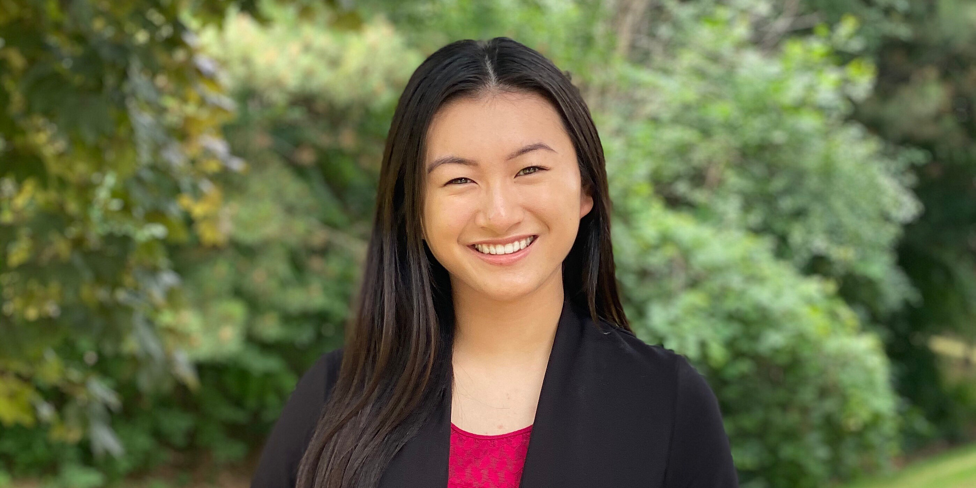 Christine smiling in a suit