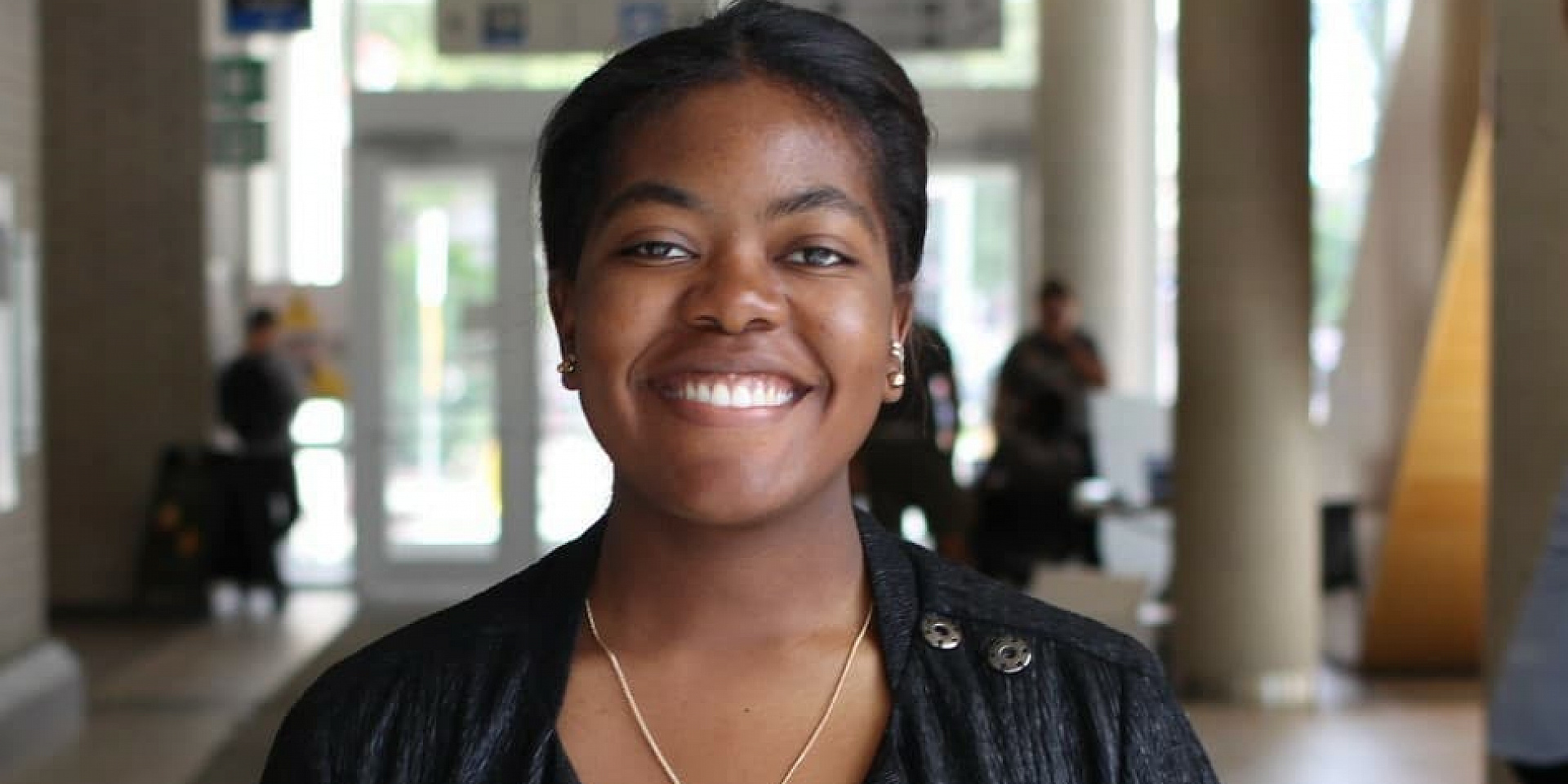 Glory Angela smiling in Desmarais hall