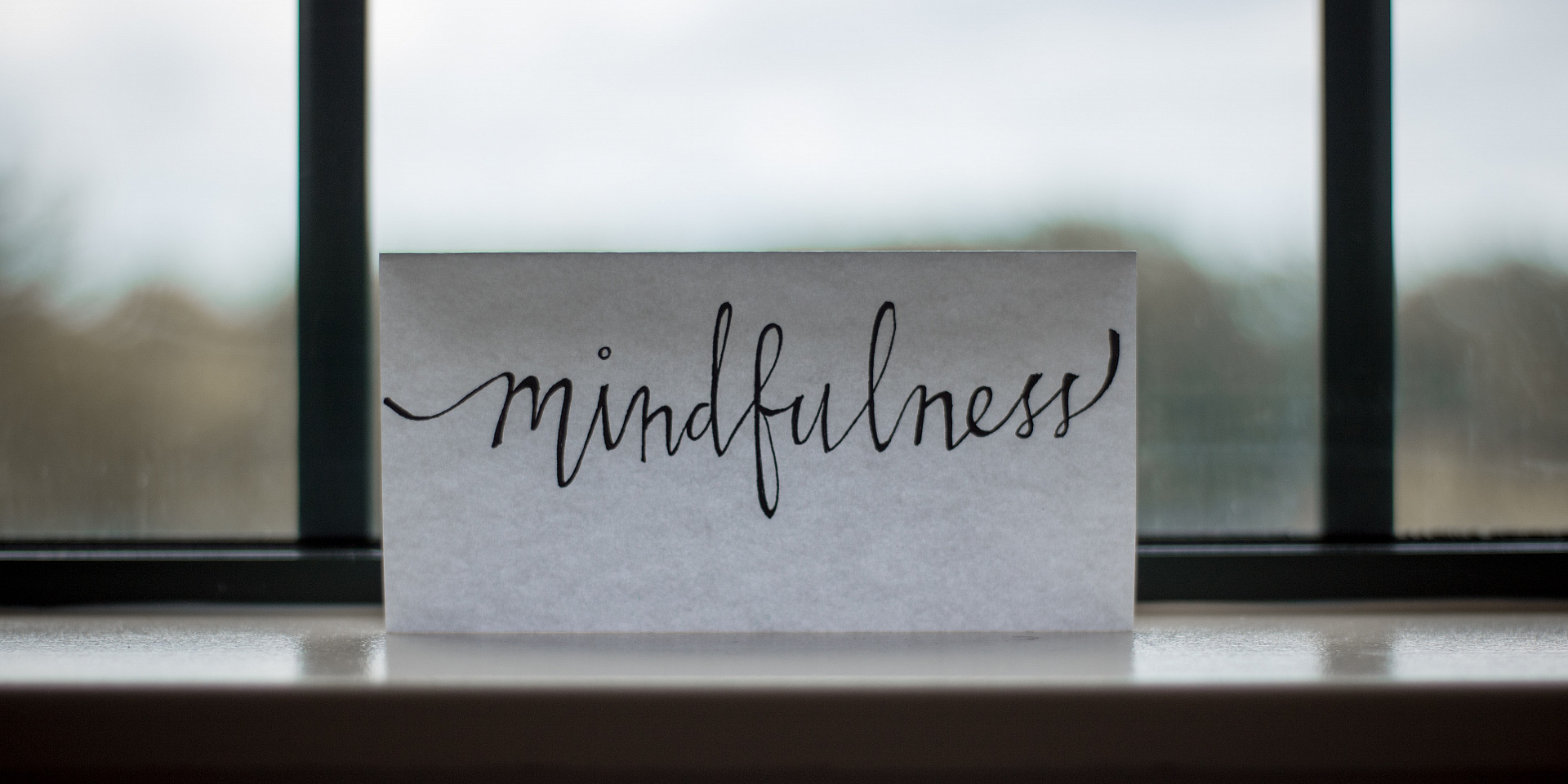 Piece of paper with the word mindfulness written on it.