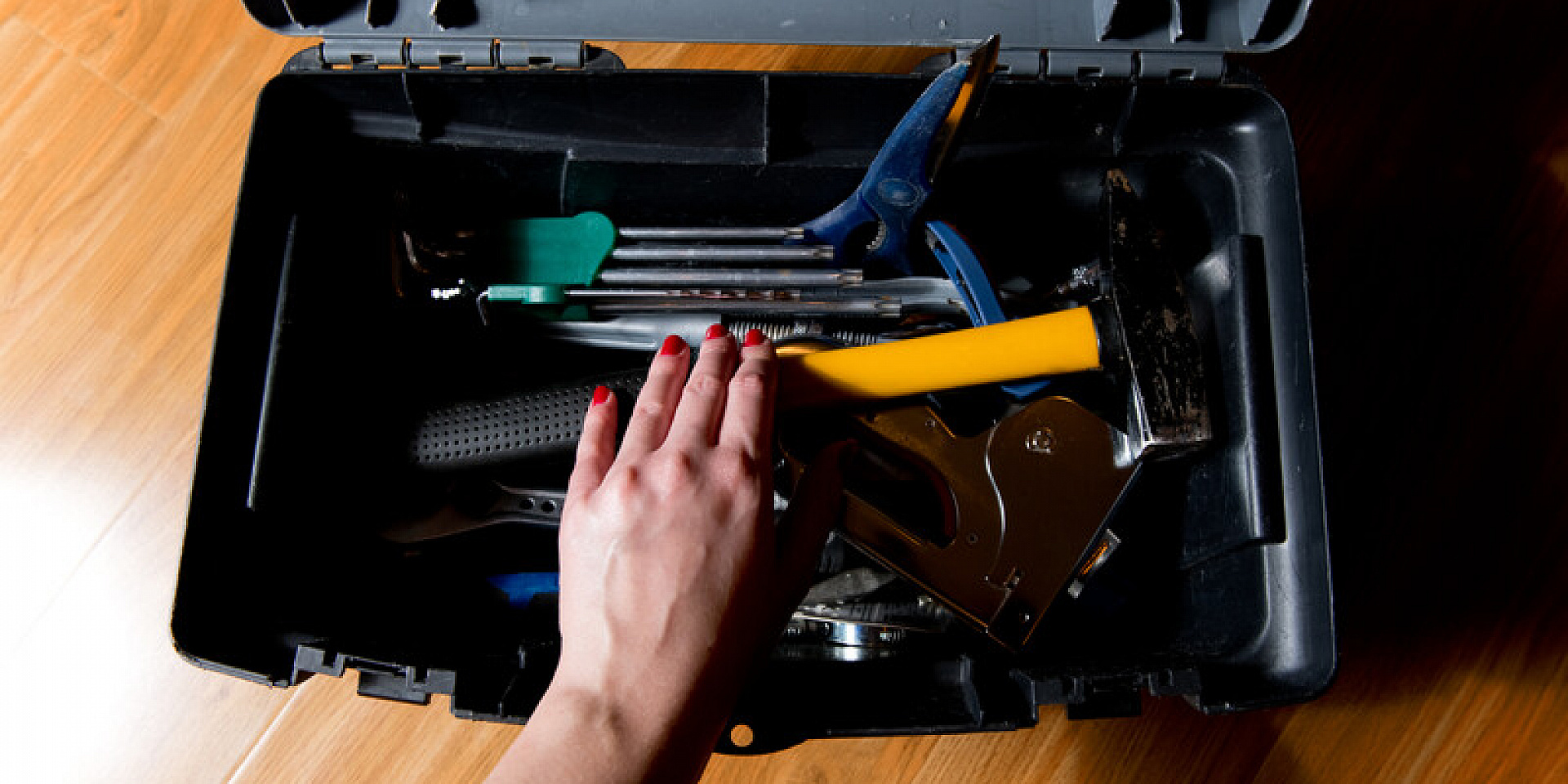 Black toolbox with different tools inside.