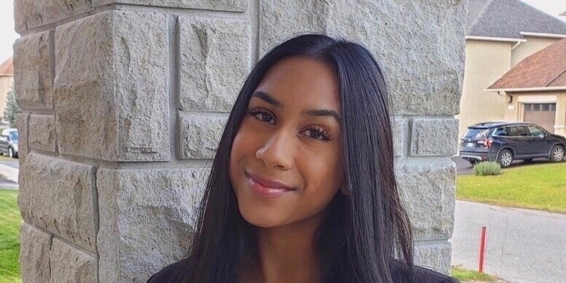 Karishma Kanagarajah smiling outside of a house