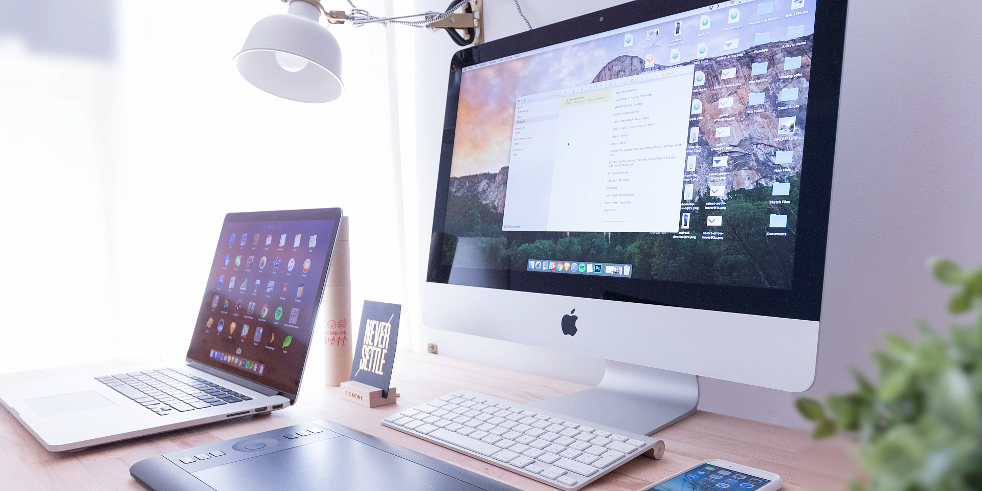 Organized computer desk with laptop, screen and phone.