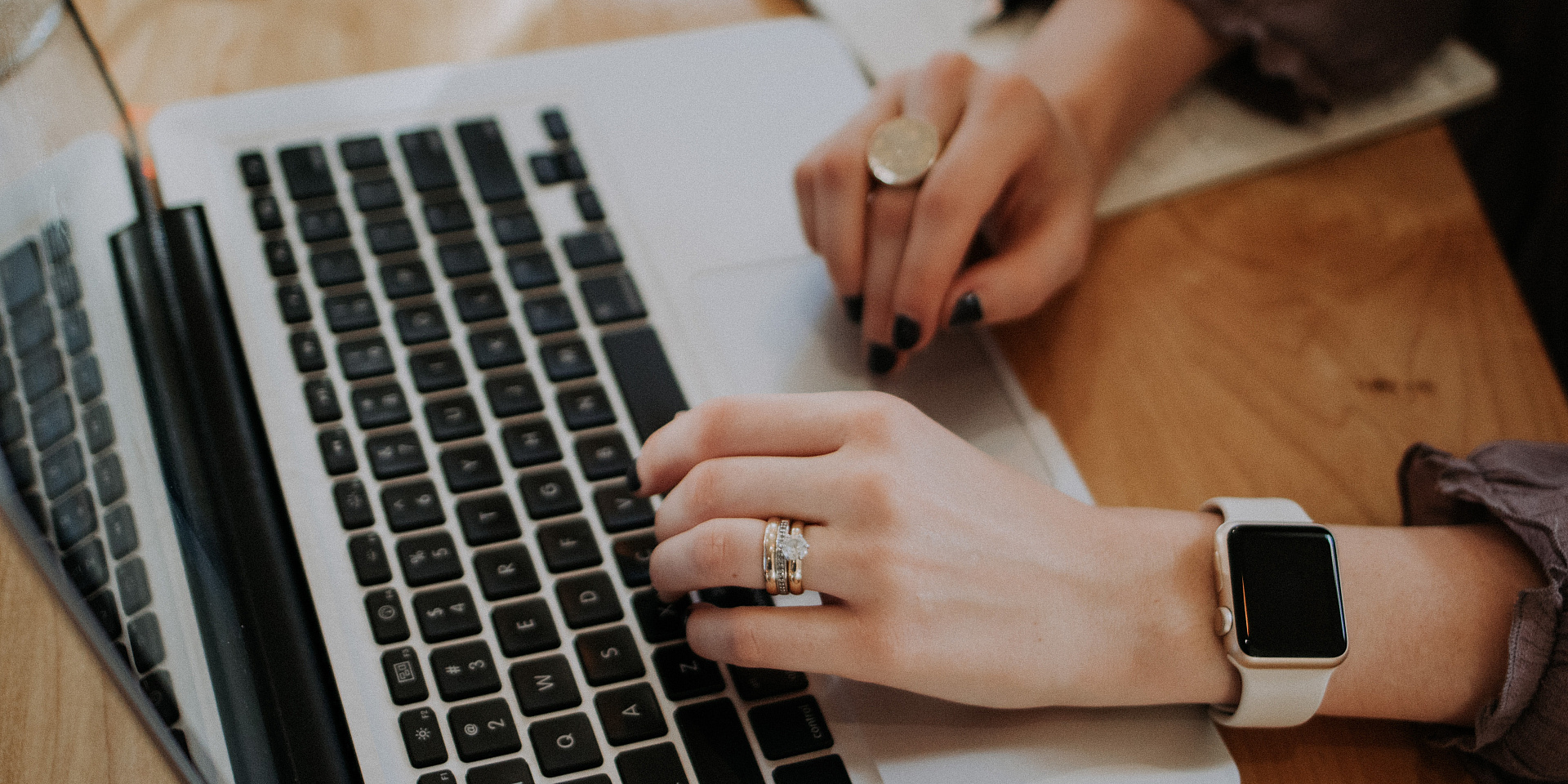 Hands typing on a laptop.