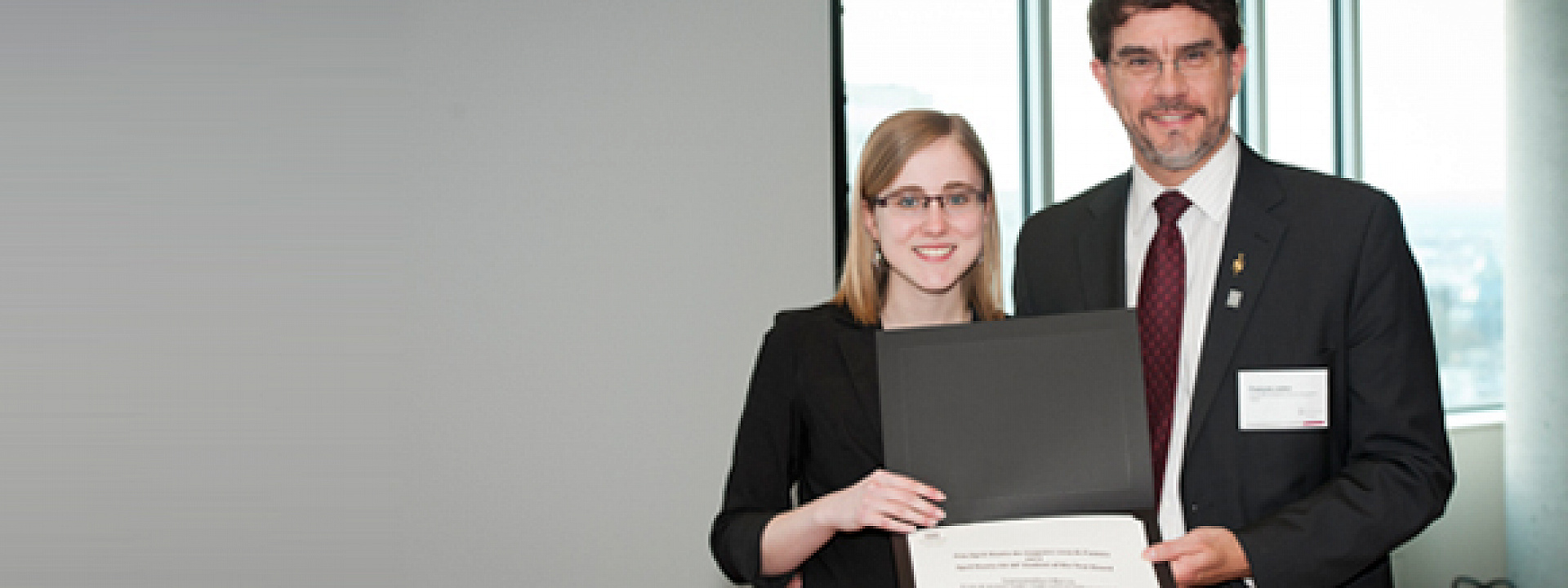 Samantha Harris, with Dean François Julien, holding a certificate