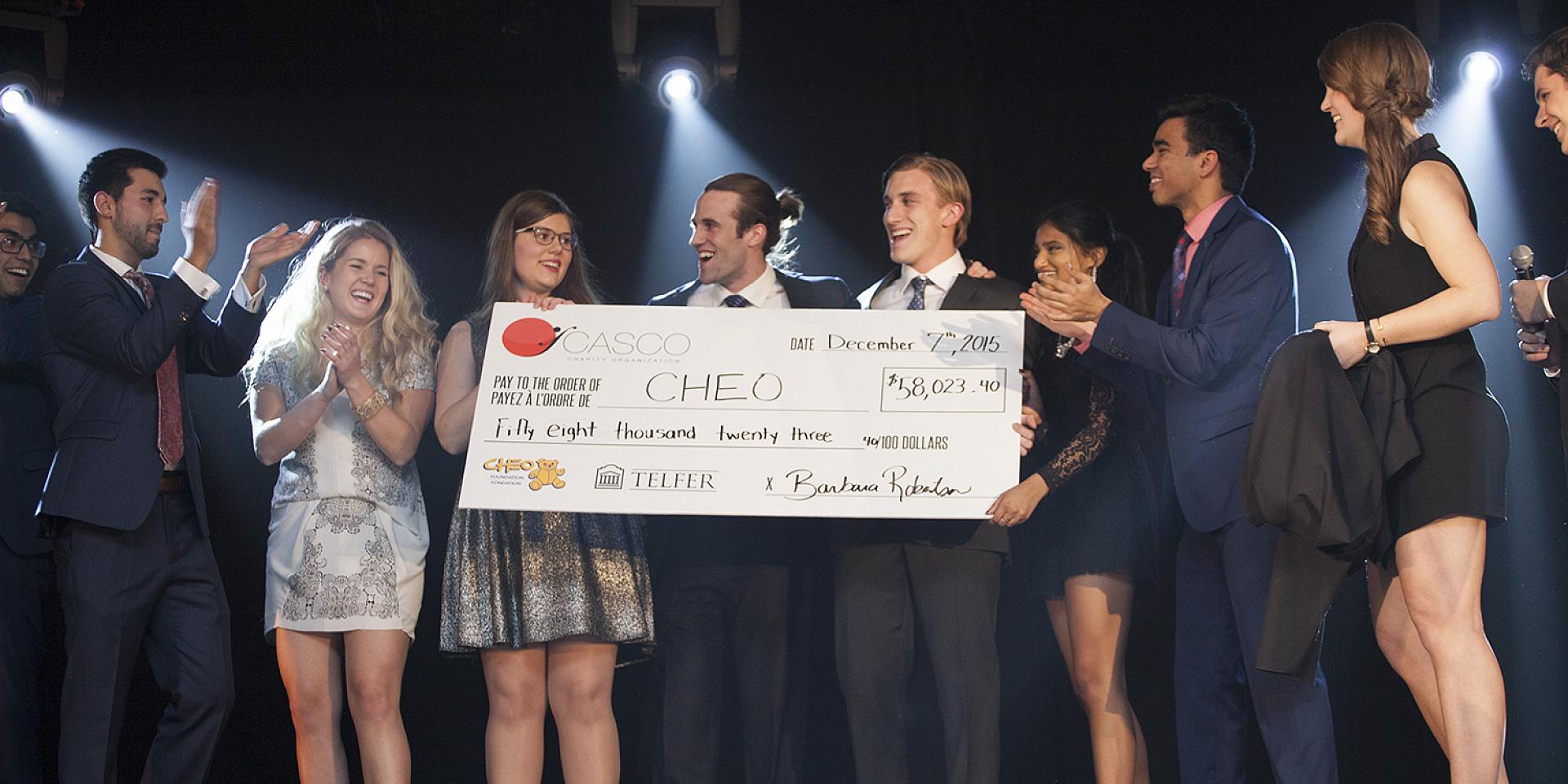 Students with cheque