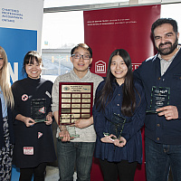 Students holding a plaque 