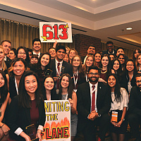 A large group of students posing together at an academic competiton.
