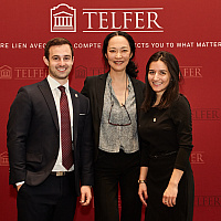winners of the finance capstone standing with their professor in front of a branded backdrop.