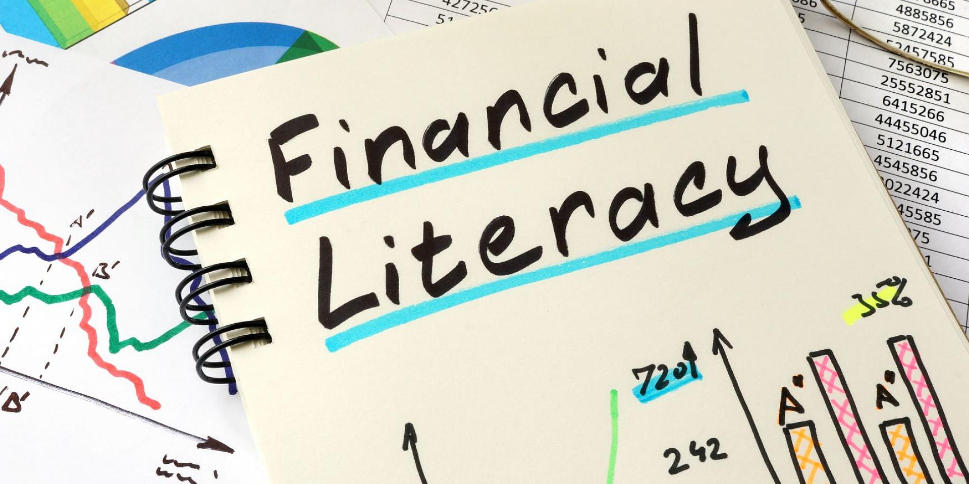 Notebook with graphs and "Financial Literacy" written on top of it