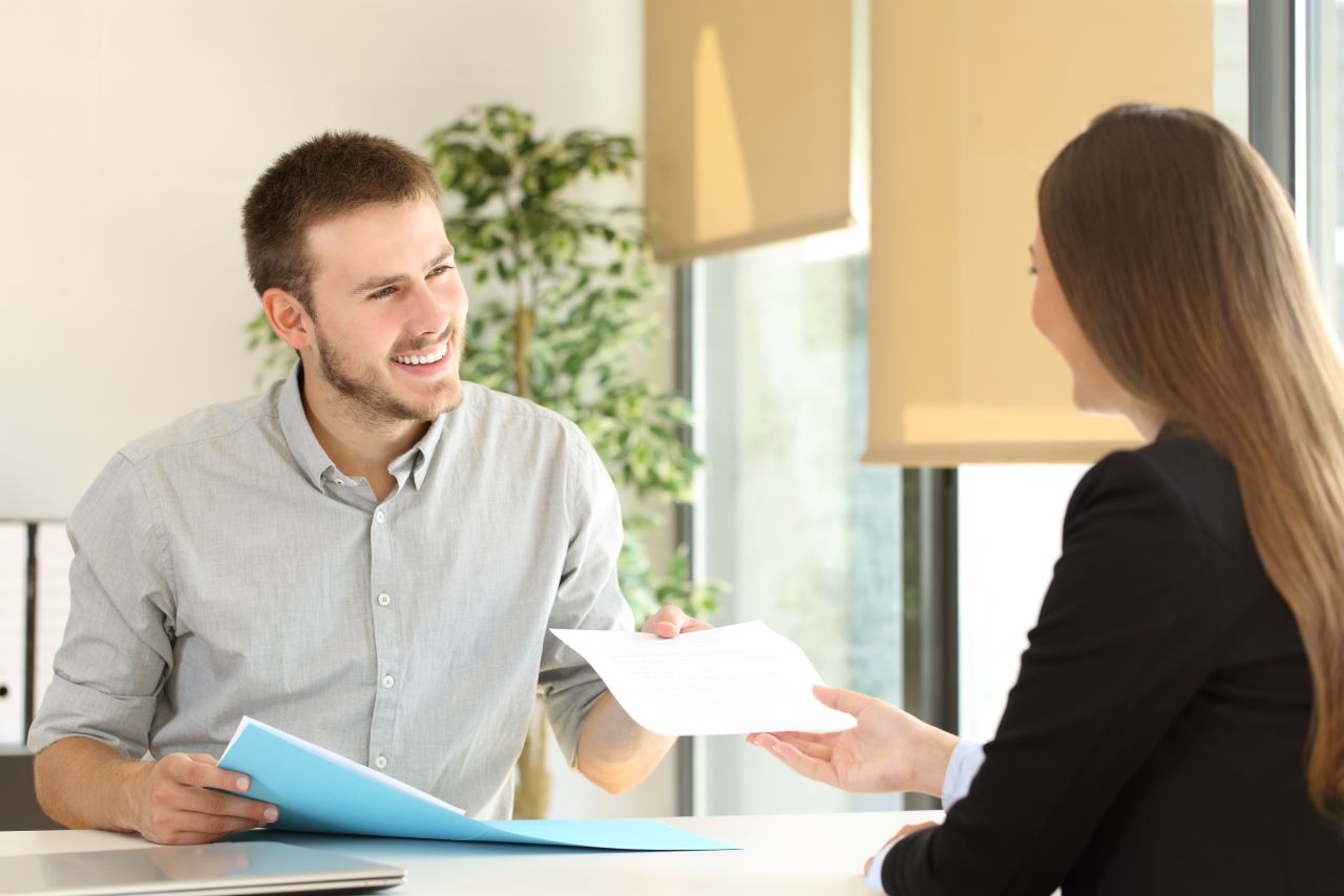 Man handing over CV