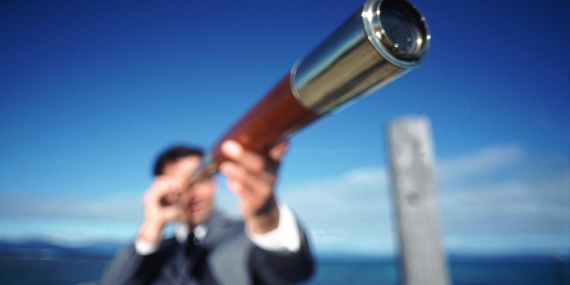 Man looking through telescope