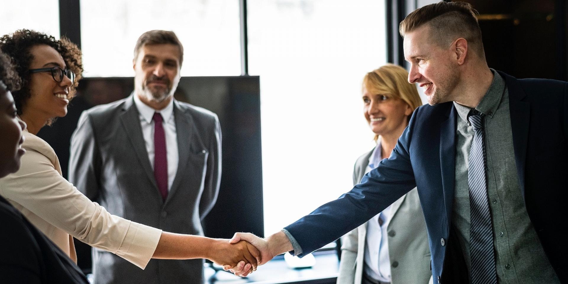 Man shaking women's hand