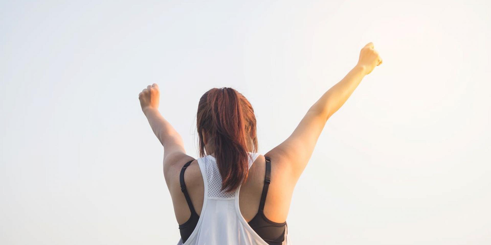 Woman cheering to the sky