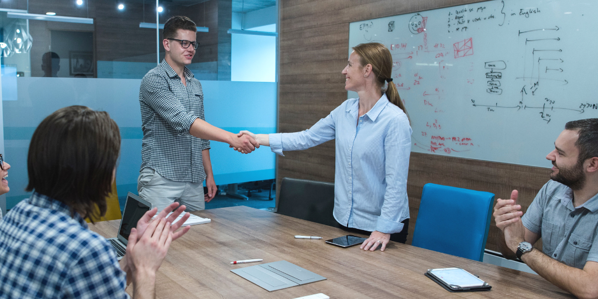 People shaking hands at group meeting