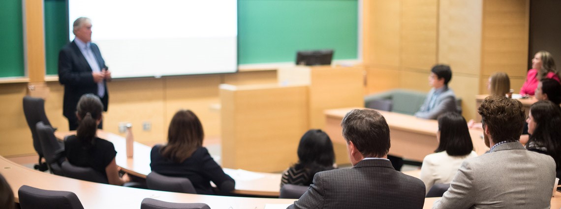 Students attending a class with professor in front