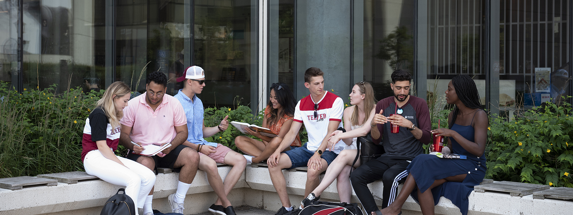 Telfer students sitting and studying in front of the large windows outside of the Faculty of Social Science (FSS)