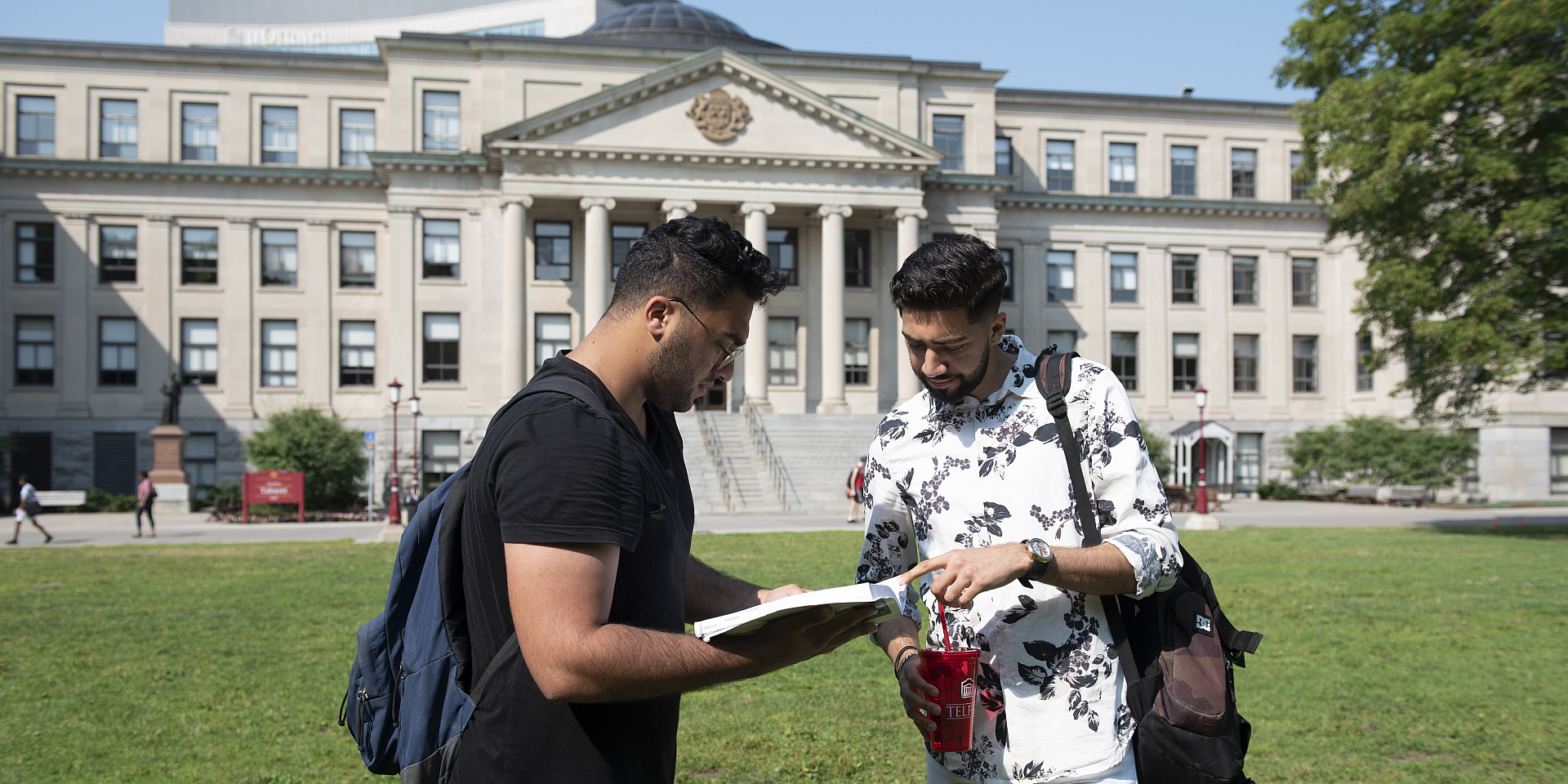 Telfer students studying on the Tabaret lawn with their textbooks