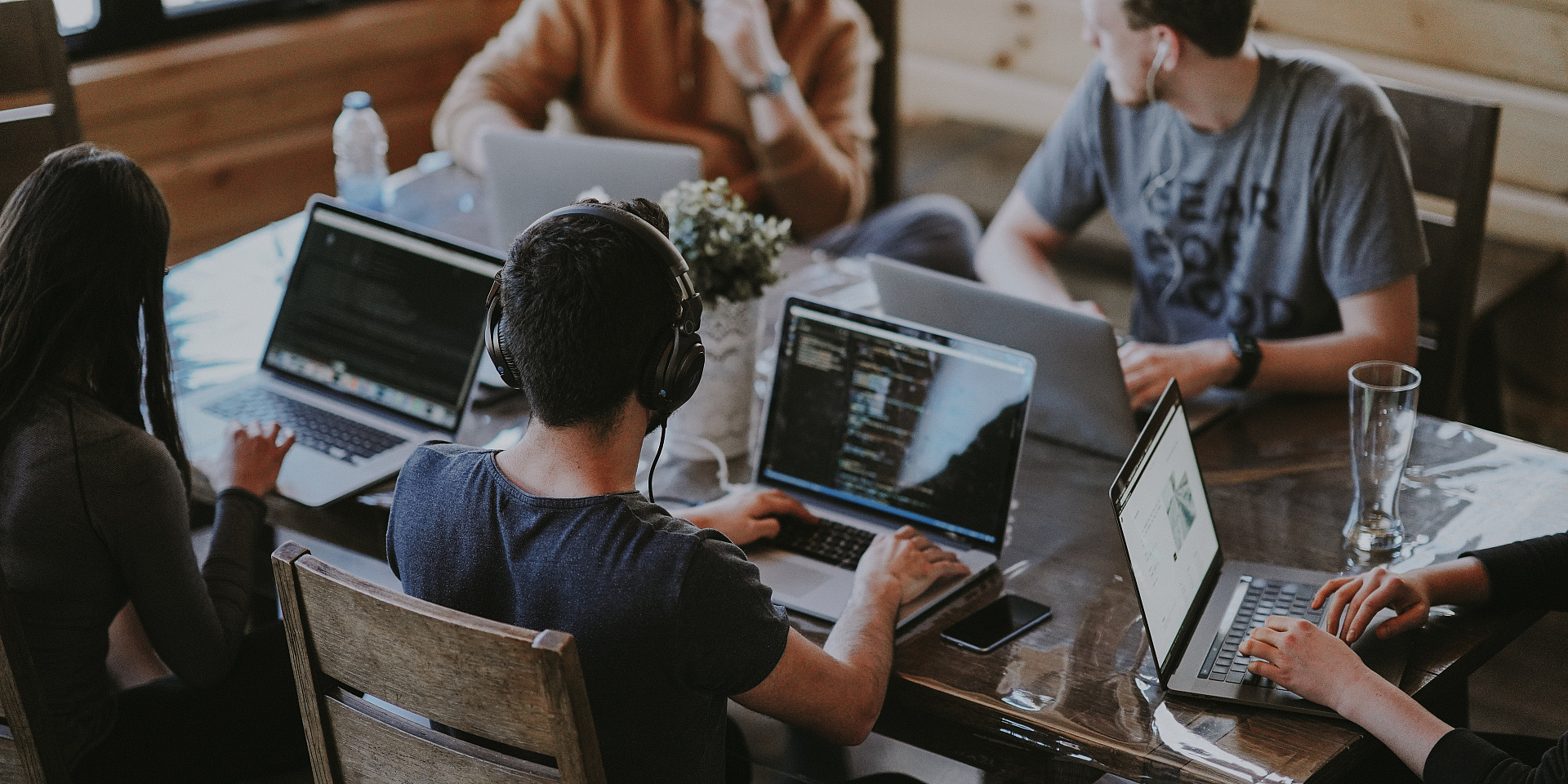 Group of people working together on laptops