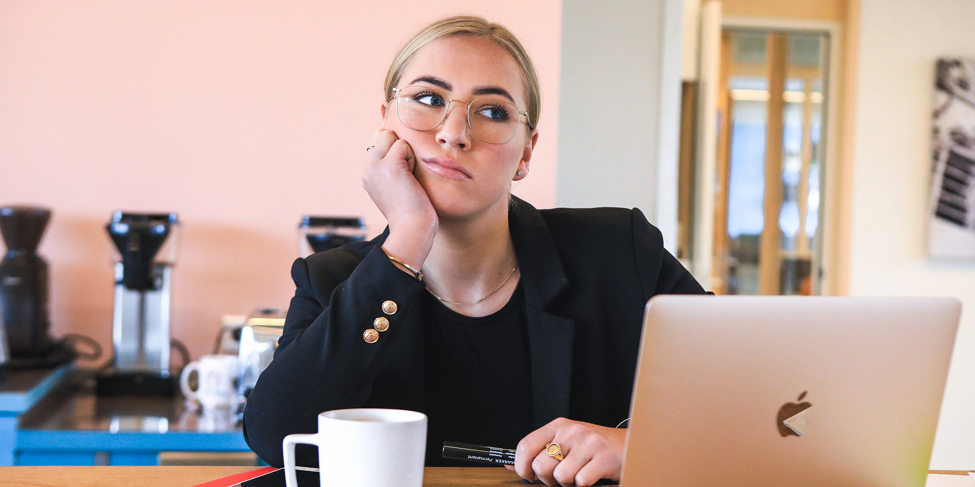 Woman working on laptop looking distracted