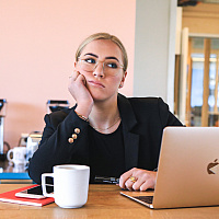 Woman working on laptop looking distracted