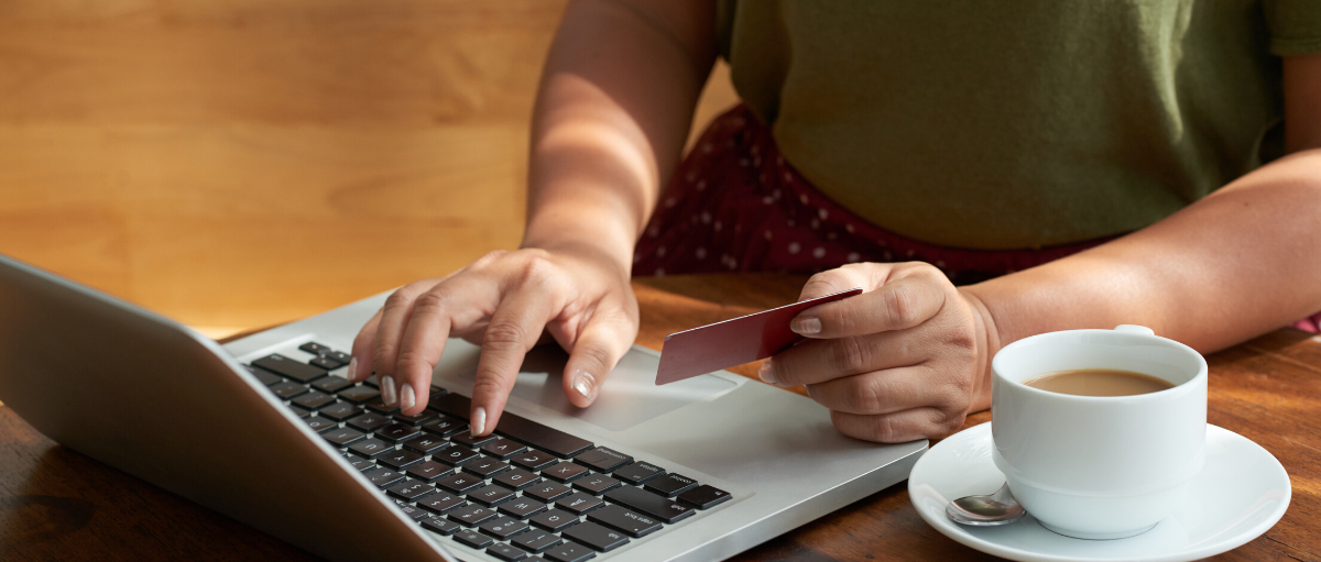 person shopping online holding credit card