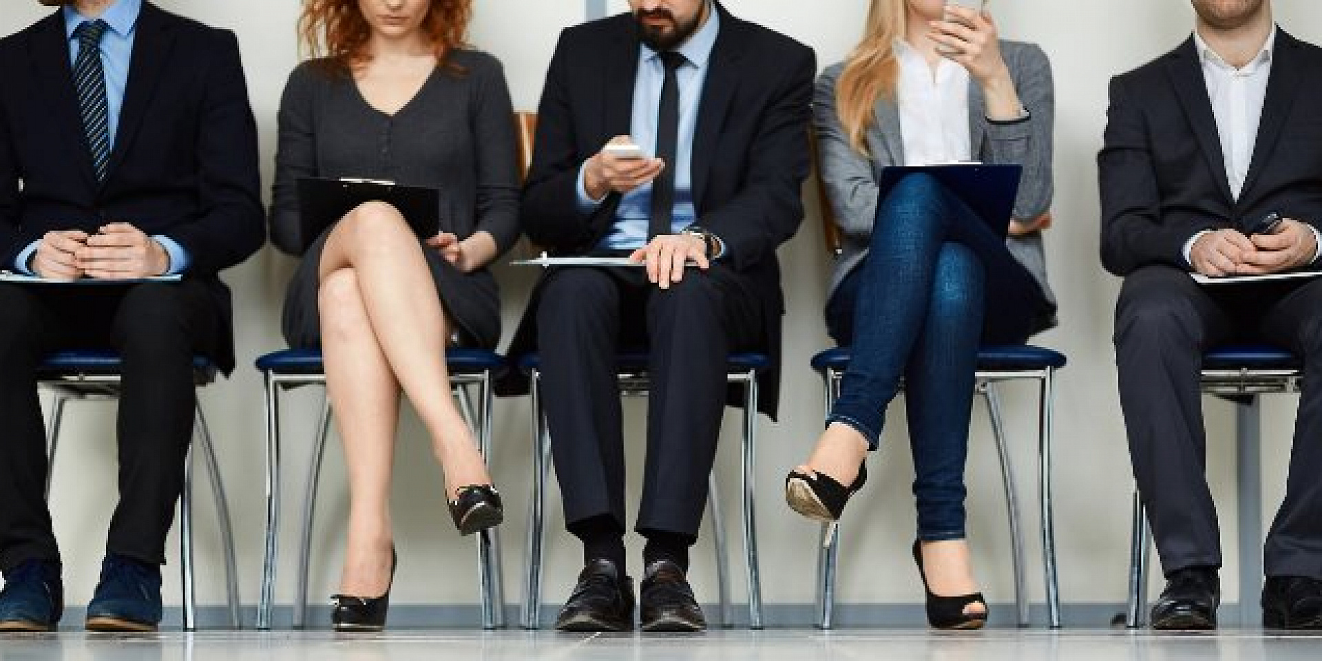 Busy business people sitting on chairs.