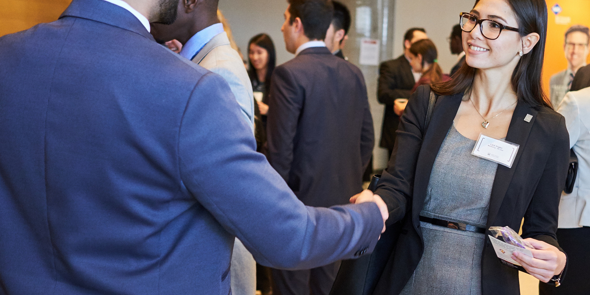 Two professionals talking at a networking event.