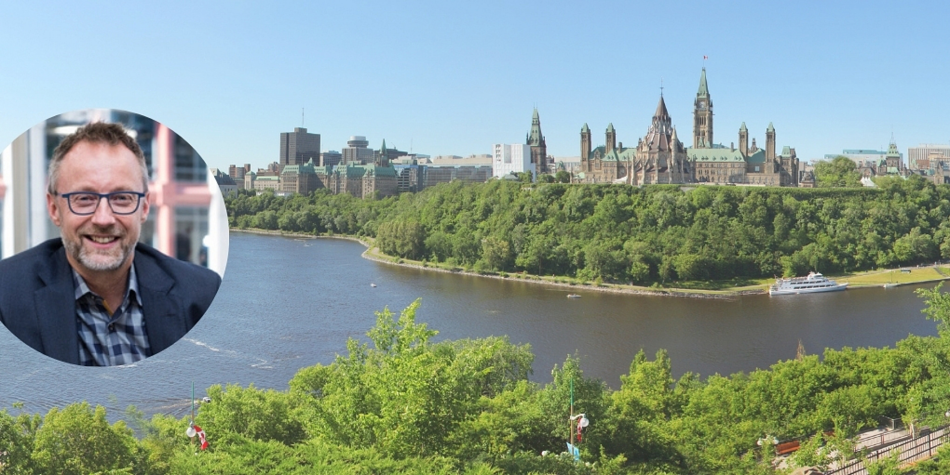 Glen Orsak smiling over an skyline view of Ottawa