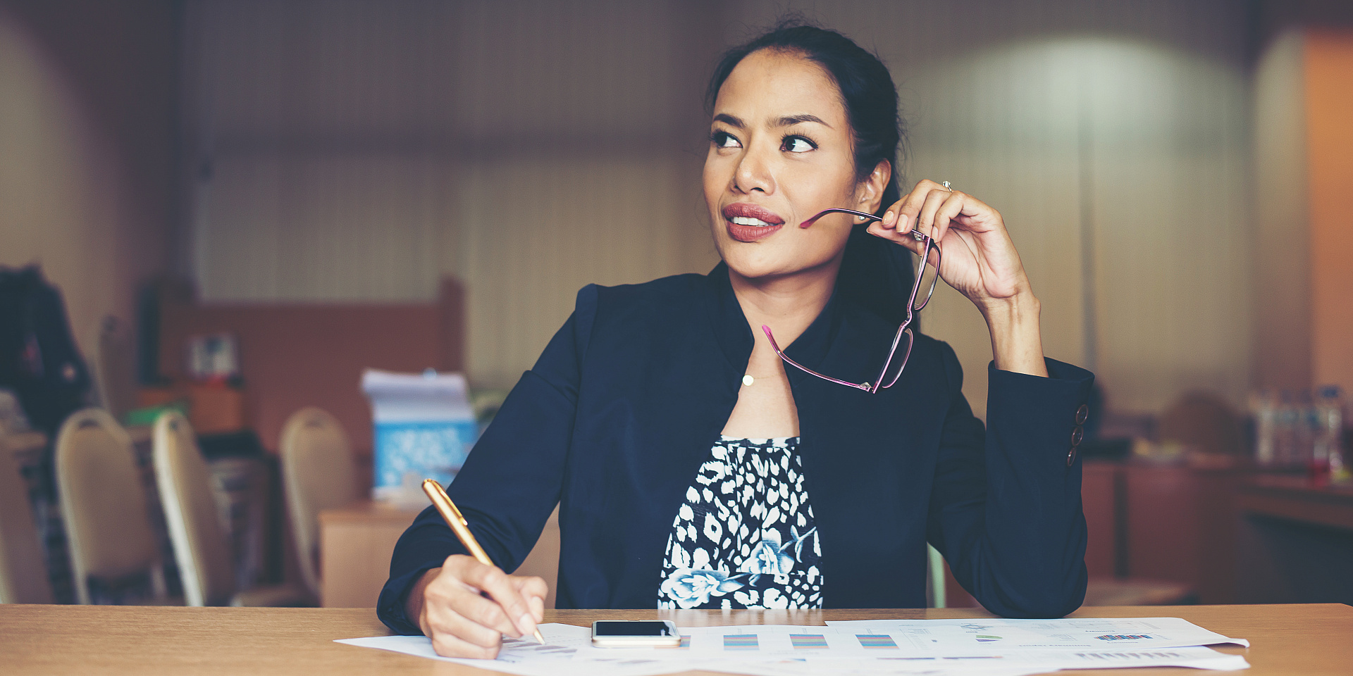 business woman working at office holding glasses