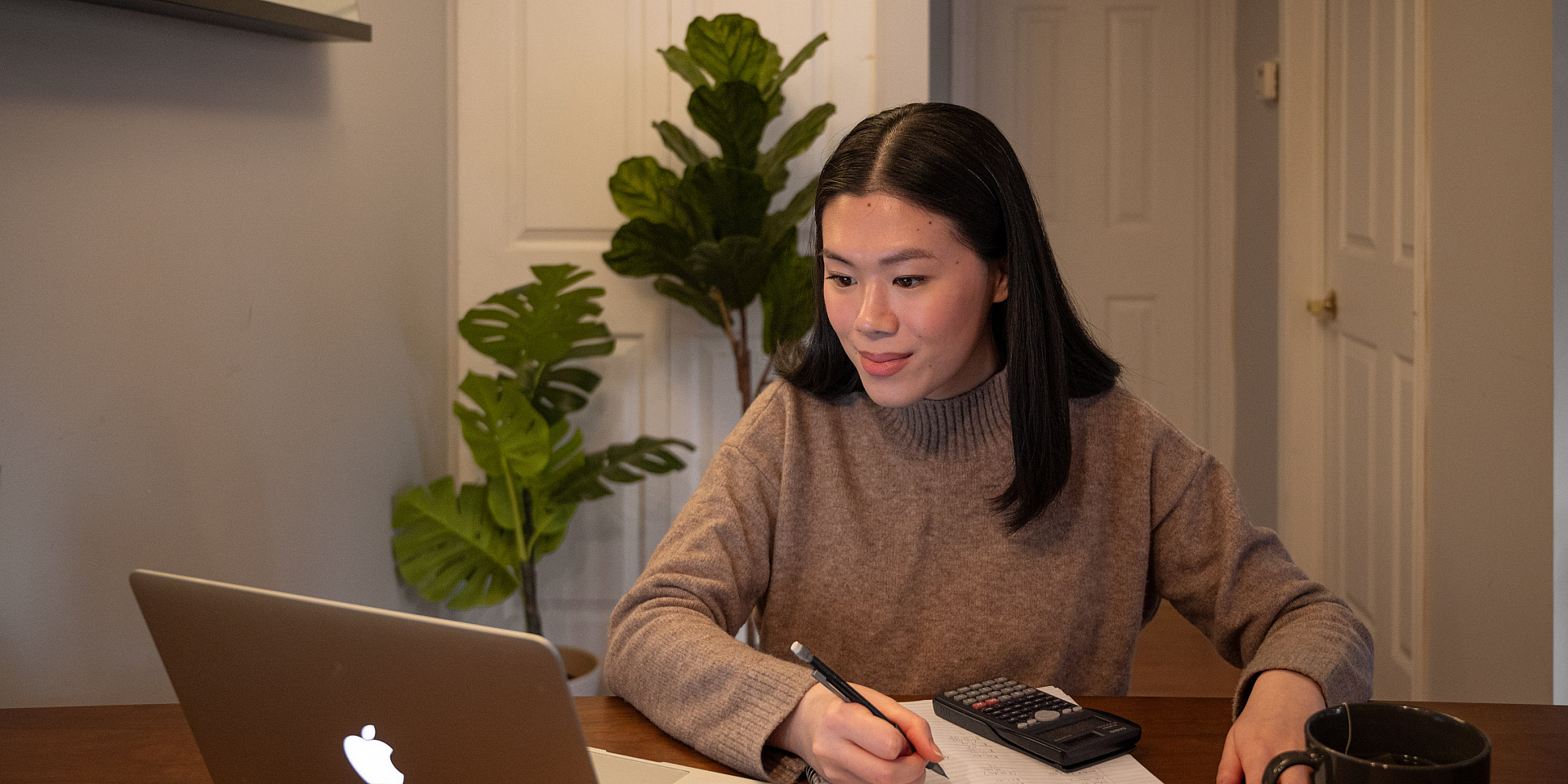 young lady studying from home on her computer