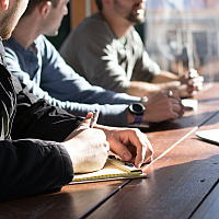 group of colleague discussing around a meeting table