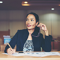 business woman working at office holding glasses