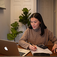 young lady studying from home on her computer