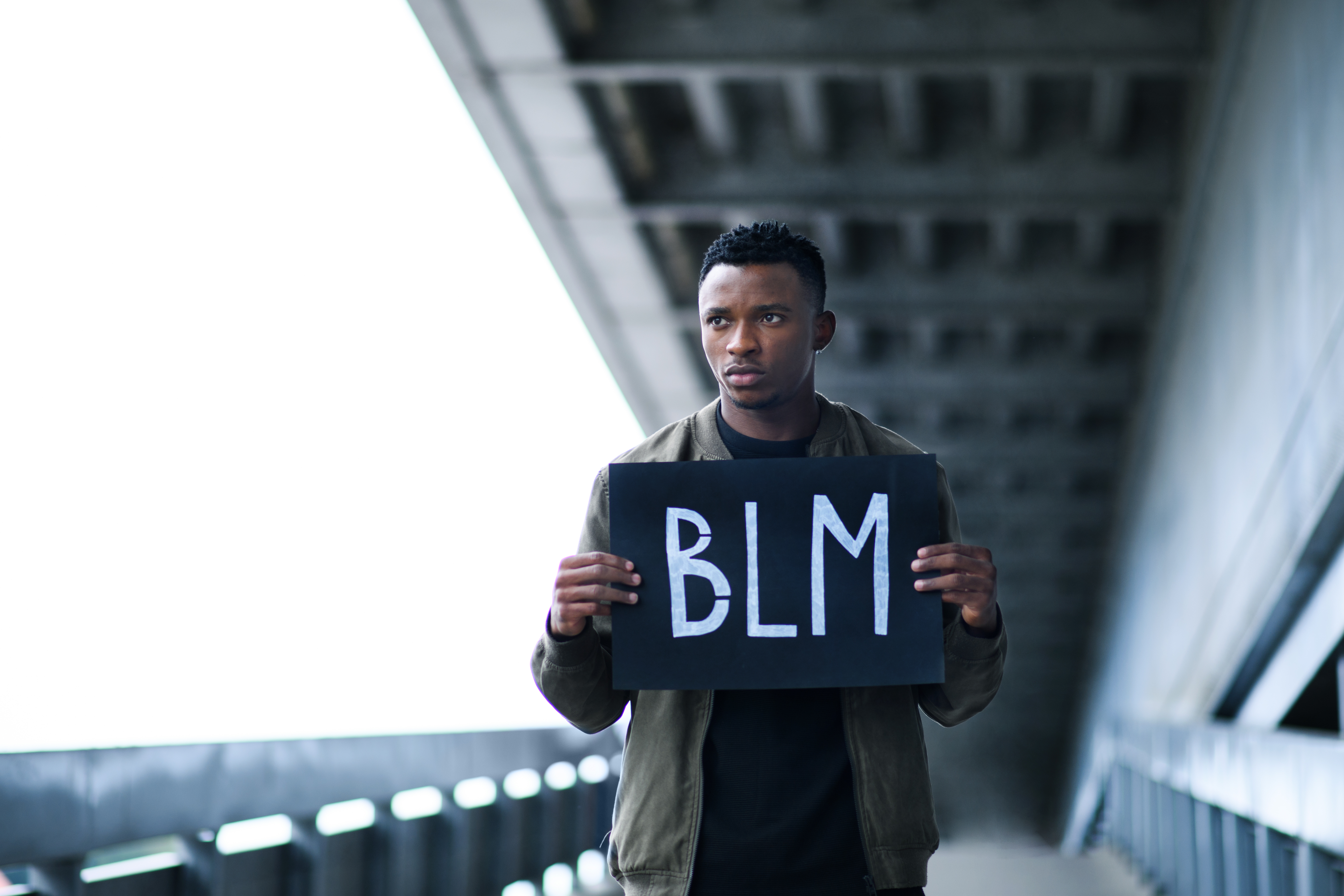 BLM young man hoding sign