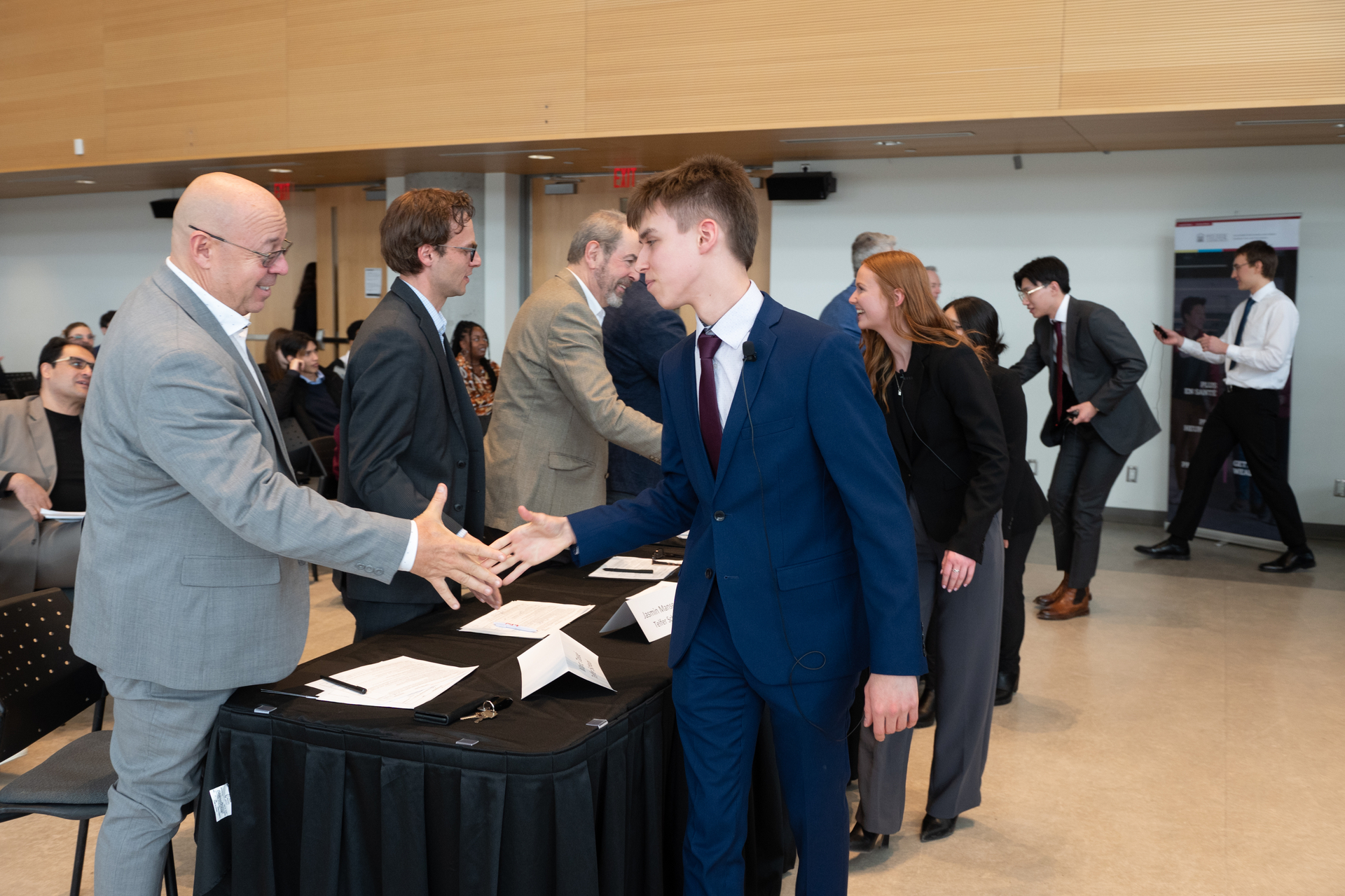 Student shaking hand with professor