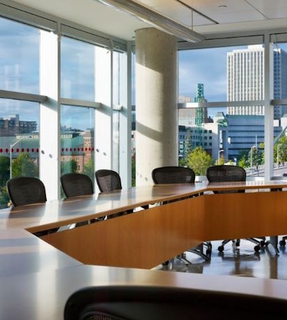 Boardroom in the Desmarais Building, University of Ottawa campus, featuring large windows overlooking other buildings.
