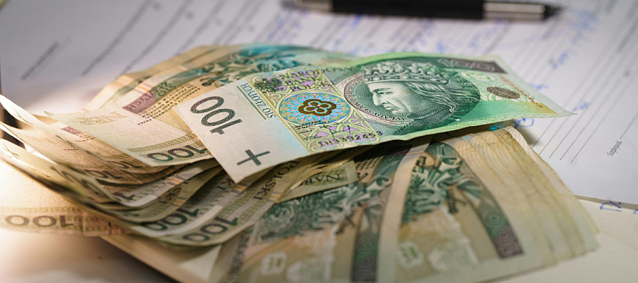 stack of cash on top of a loan agreement