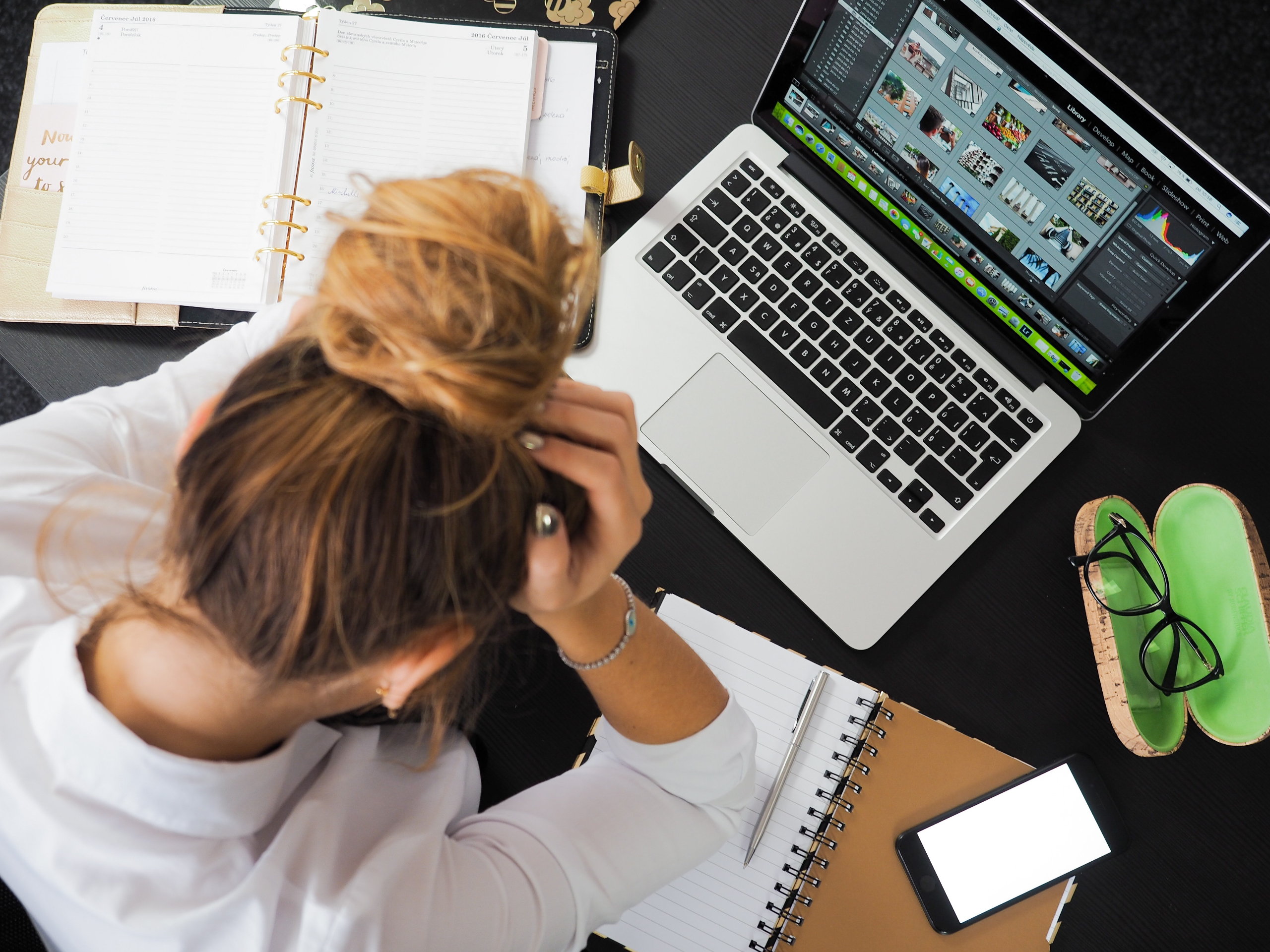 Student under stress while studying in front of a laptop