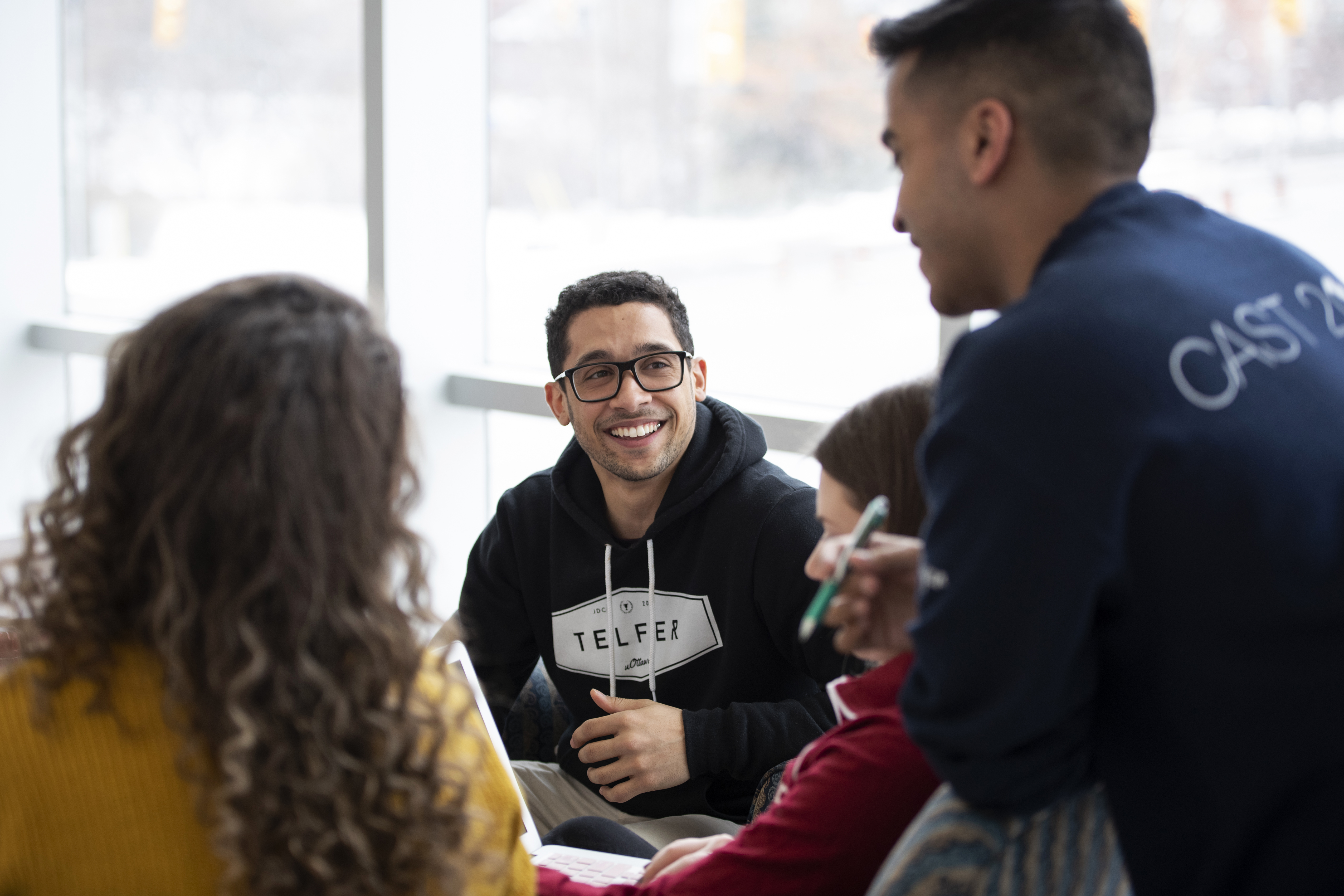 Group of Telfer students studying together in Desmarais building