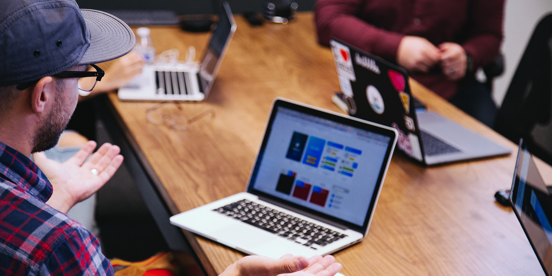 entrepreneur looking at his laptop with hands held out in confusion