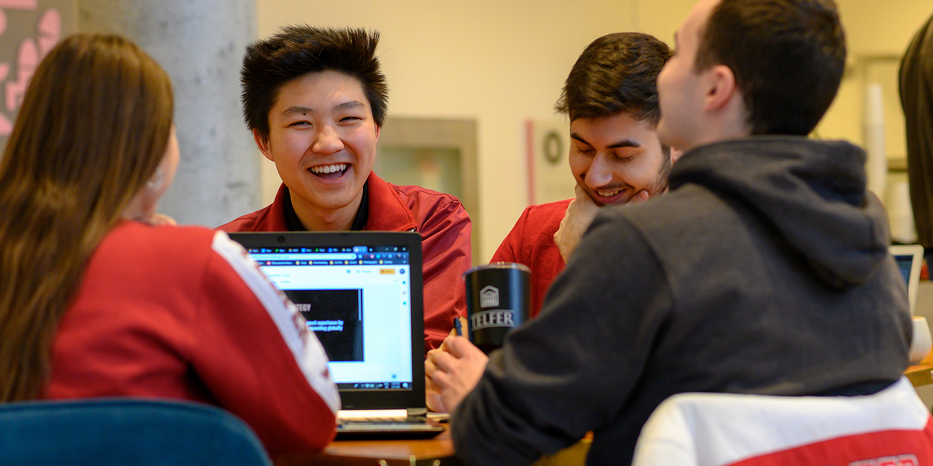 Group of Telfer students studying and laughing together