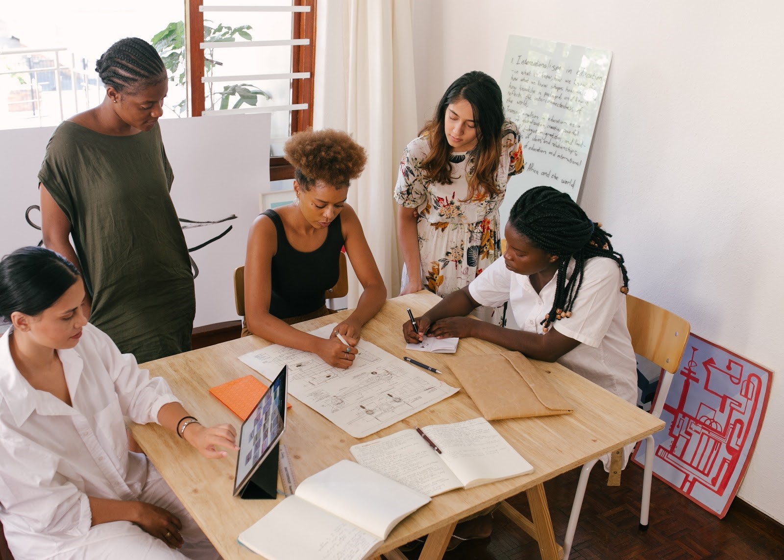 Group of women talking and working around a table